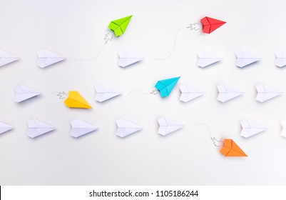 Group of paper planes in one direction and with one group individual pointing in the different way. Business for innovative solution concept.