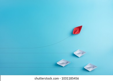 Group of paper ship in one direction and with one individual pointing in the different way. Business concept for innovative solution. - Shutterstock ID 1031185456