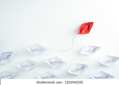 Group Of Paper Ship In One Direction And One Individual Pointing In Different Way. Innovative Solution For Business Concept.