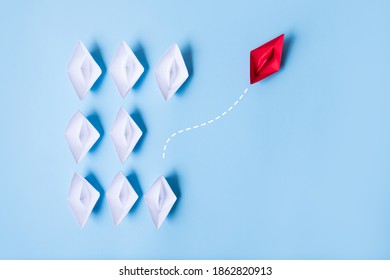 Group of paper ships in one direction and with one individual pointing in the different way, leadership, individuality concepts. - Shutterstock ID 1862820913