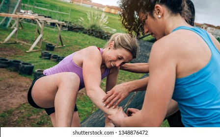 Group of participants in an obstacle course climbing a pyramid obstacle - Powered by Shutterstock