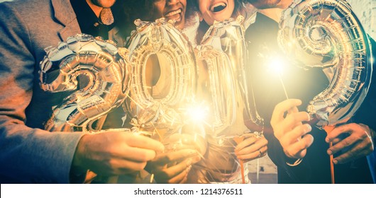 Group of party people celebrating the arrival of 2019, men and women looking into camera