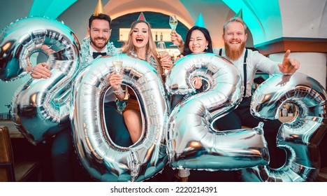 Group of party people celebrating the arrival of 2023