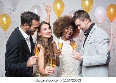 Group of party people celebrating with drinks a birthday or New years eve party