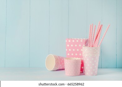 Group Of Party Supplies On Blue Wooden Table Background, Pink Paper Cup With Pink Straws And Popcorn Box With White Polka Dot Pattern, Vintage Background