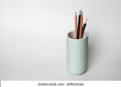 Group Of Pencil In Green Ceramic Cup On White Background