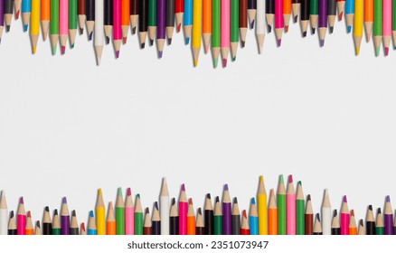 group of pencils of many colors on a white sheet of paper - Powered by Shutterstock