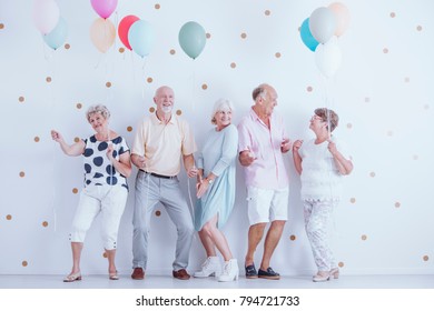 Group of pensioners dancing at a new year's celebration party - Powered by Shutterstock