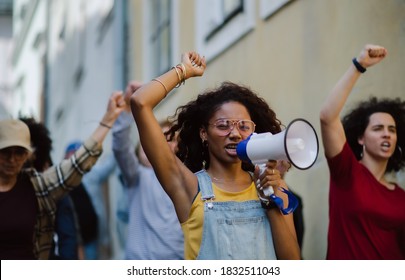 Group of people activists protesting on streets, strike and demonstration concept. - Shutterstock ID 1832511043