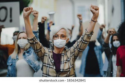 Group of people activists protesting on streets, women march, demonstration and coronavirus concept. - Powered by Shutterstock