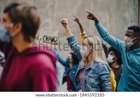 Group of people activists protesting on streets, strike and demonstration concept.