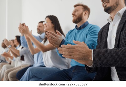 Group of people applauding. Happy audience clapping hands at public conference. Team of male and female attendees giving round of applause to express respect and gratitude for interesting lecture - Shutterstock ID 2277535589