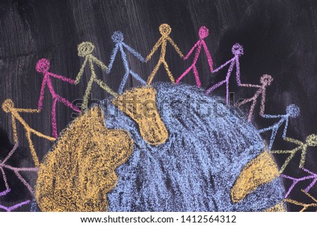 Group of people around the world. Chalk drawing. Blackboard. Close up.