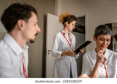 group of people caucasian women and man prepare for business conference in hotel room male and female businessman and woman manager or salesman talk while getting ready for sales presentation - Shutterstock ID 2281038259