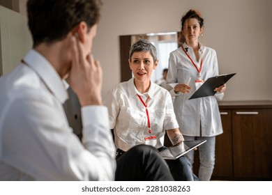 group of people caucasian women and man prepare for business conference in hotel room male and female businessman and woman manager or salesman talk while getting ready for sales presentation - Shutterstock ID 2281038263