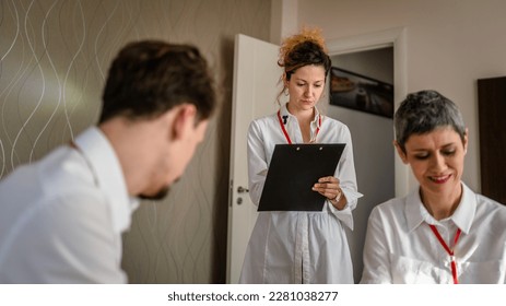 group of people caucasian women and man prepare for business conference in hotel room male and female businessman and woman manager or salesman talk while getting ready for sales presentation - Shutterstock ID 2281038277