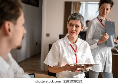 group of people caucasian women and man prepare for business conference in hotel room male and female businessman and woman manager or salesman talk while getting ready for sales presentation - Shutterstock ID 2281038281