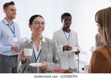 Group of people chatting during coffee break indoors - Powered by Shutterstock