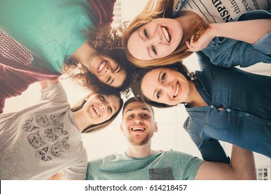 Group of people in circle . Friends looking down  . Concepts about friendship,lifestyle,unity,business and teamwork. - Shutterstock ID 614218457