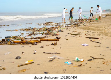  Group Of People Cleaning Up The Beach From The Garbage And Plastic Waste. Bali Island, Indonesia