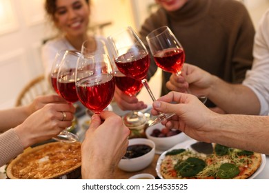 Group Of People Clinking Glasses With Red Wine During Brunch At Table Indoors, Closeup