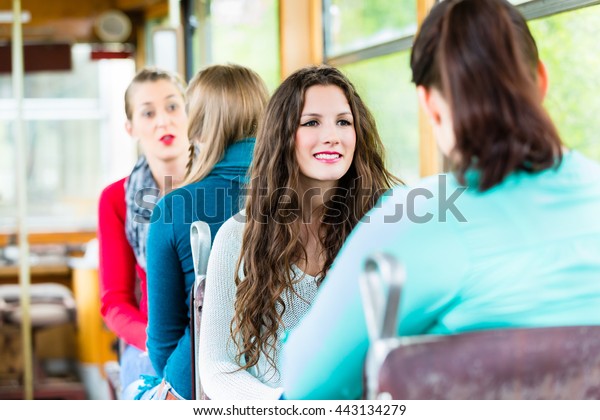 Group of people\
commuting in tram or cable\
car
