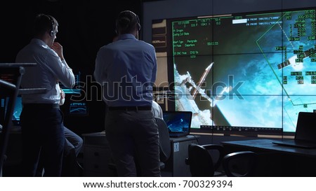 A group of people are controlling the orbiting international space station ISS. Elements of this image furnished by NASA.