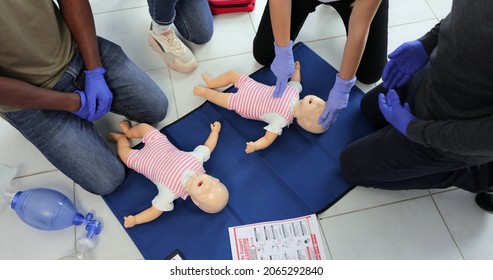 Group of people CPR First Aid Baby Training course. Baby CPR dummy first aid training. - Powered by Shutterstock