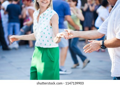 Group Of People Dancing Swing In The Street From Feet Perspective