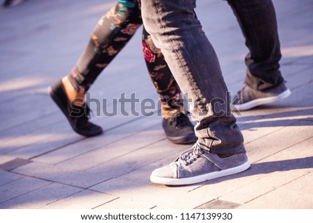 Group of people dancing swing in the street from feet perspective