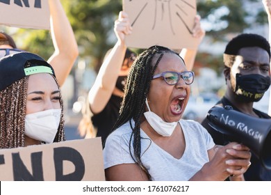 Group Of People Demonstrators Protest In City Street Against Racism - Equal Rights Fighting And Black Lives Matter Campaign Concept - Focus On African Woman Face