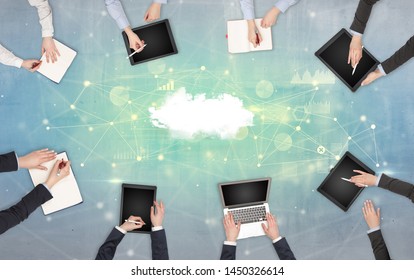 Group of people with devices in hands working on reports with online teamwork and cloud technology concept Stock Photo