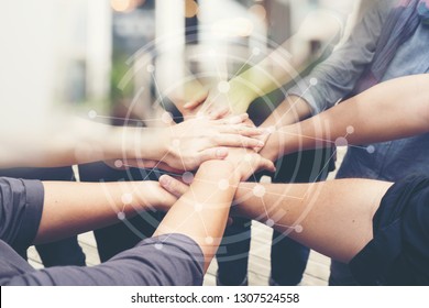 Group Of People Of Different Nationalities, Putting Hand Togetherness Teamwork Or Handshake Is Alliance Community Connection,  Business Partner.
Team Stacked With Graphic Connected Networks.