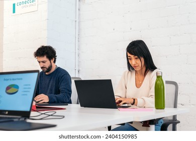 Group of people of different races working concentrated and happy with laptops in a coworking office - Powered by Shutterstock