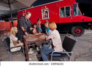 Group Of People Dining At Pizza Canteen Outside