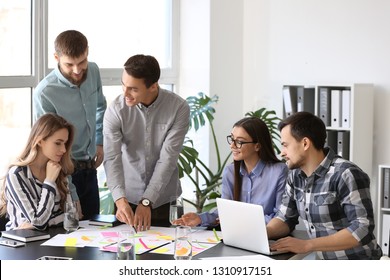 Group of people discussing business plan in office - Shutterstock ID 1310917151