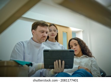 Group Of People Of Doctor, Nurse Assistant And Patient In Moment Of Explain Discussion Examining The Way To Treat Dentistry Of The Tooth, Dentist Clinic On Duty Of Works With Customer Patient Moment.