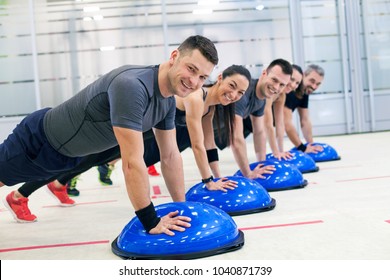 Group of people doing exercise on bosu ball.  - Powered by Shutterstock