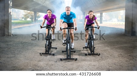 group of people doing spinning on cycle bike outdoor
