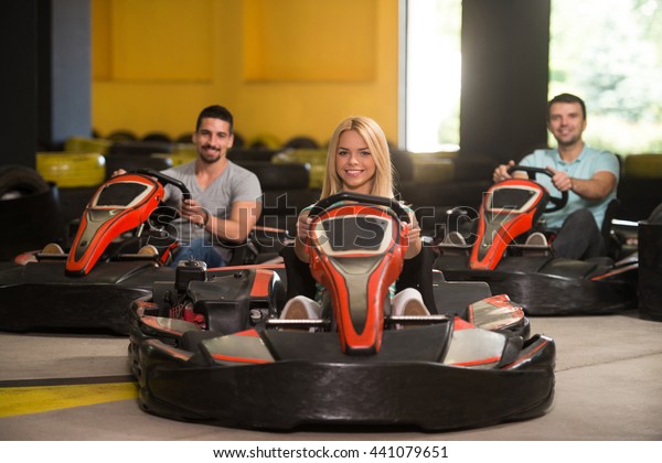 Group\
Of People Is Driving Go-Kart Car With Speed In A Playground Racing\
Track - Go Kart Is A Popular Leisure Motor\
Sports
