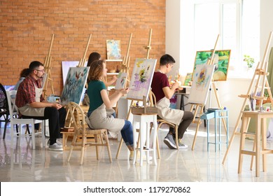 Group of people during classes in school of painters - Powered by Shutterstock