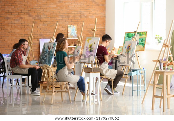 Group of\
people during classes in school of\
painters