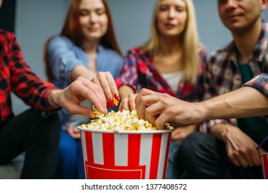 Group Of People Eating Popcorn In Cinema