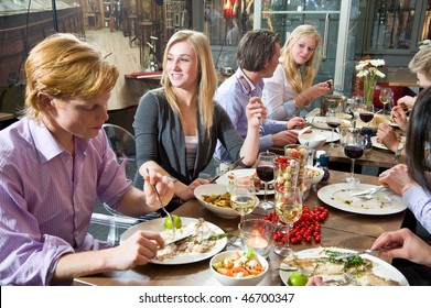 Group Of People Enjoying A Rich Dinner In A Restaurant