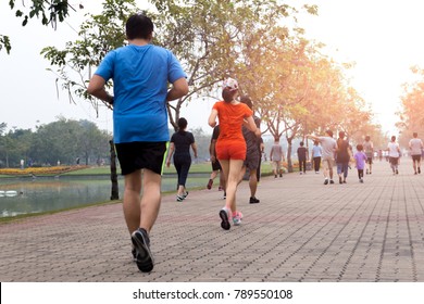 Group Of People Exercise Walking And Jogging In The Park In Morning