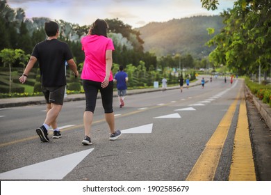 Group Of People Exercise Walking In The Park In Morning. Healthy Concept