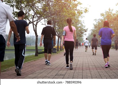 Group of people exercise walking in the park in morning
