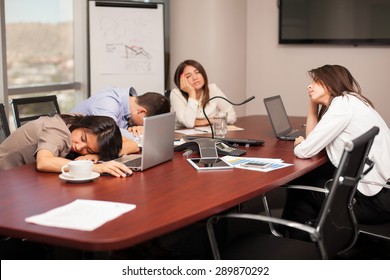 Group of people falling asleep in a meeting room after working too much