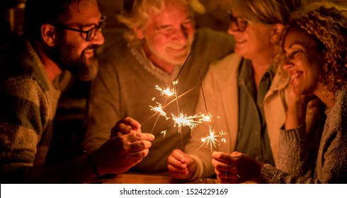 Group Of People And Family Celebrating Some Party Or New Year Together At The Terrace Of The Home - Four Sparklers At The Middle Together