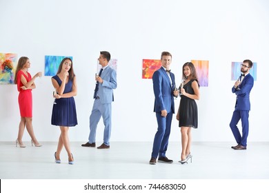 Group Of People In Formal Wear At Art Gallery Exhibition